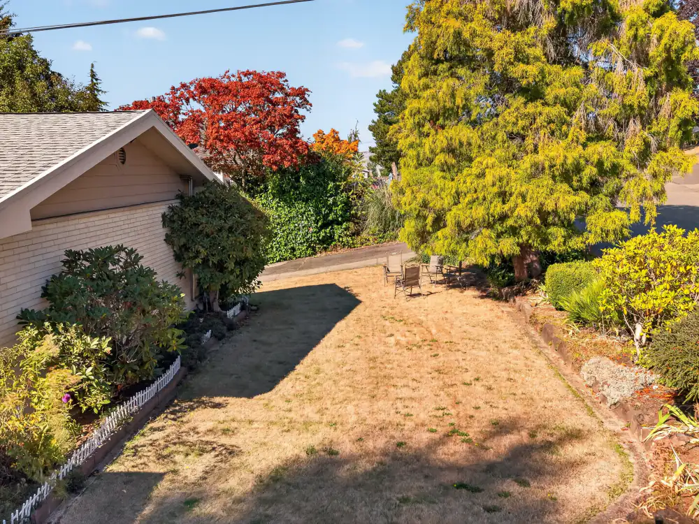 Tree-lined back yard at A Care Of Joy adult family home